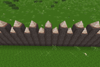 A spiked palisade made of pine logs