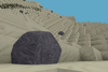 Cinematic view of boulders on a large sandy hill