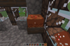 A chocolate cake sits on a table in a house