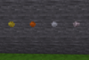 A stone wall in Minetest Game with a rivet each of brass, bronze, steel, and titanium