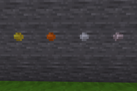 A stone wall in Minetest Game with a rivet each of brass, bronze, steel, and titanium